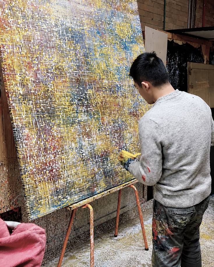 Wilson Lin 林為紳 painting a large abstract artwork in his studio, applying layered color with palette knife
